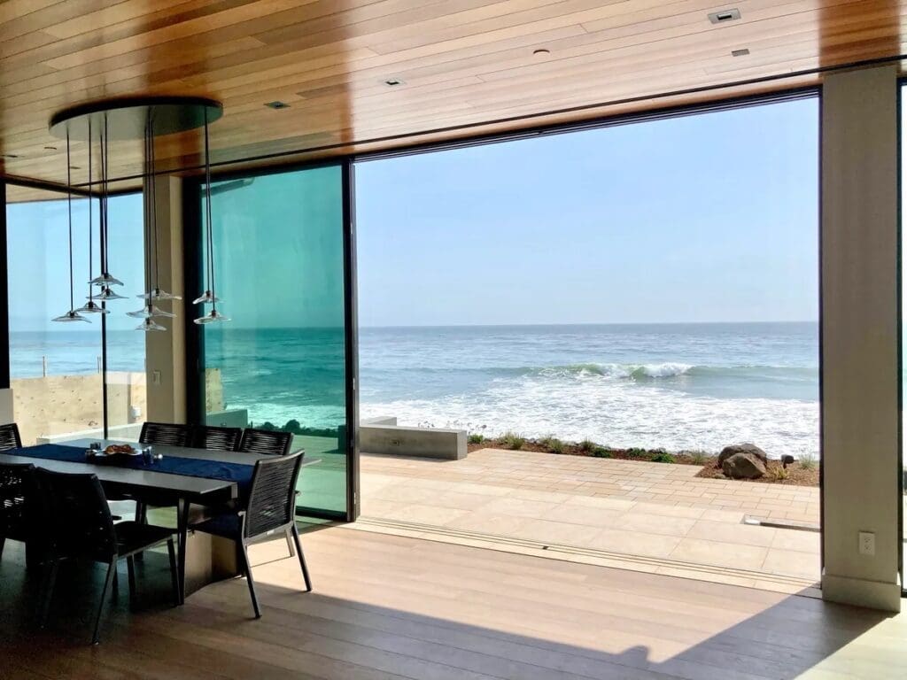 A room with a view of the ocean and beach.