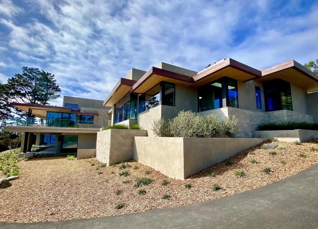 A house with a large driveway and a nice sky background