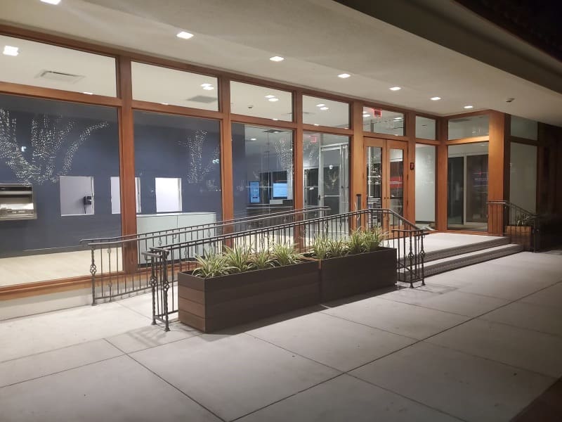 A building with a large window and a planter.