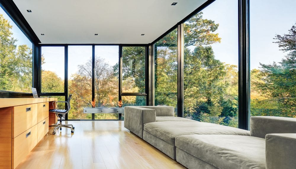 A living room with large windows and a couch