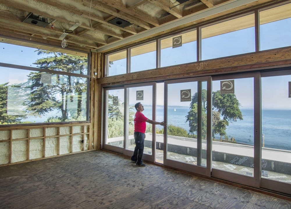 A person standing in front of a window.