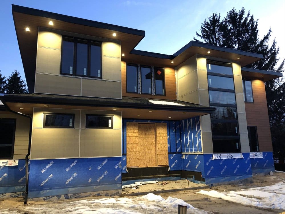 A large house with blue siding and windows.