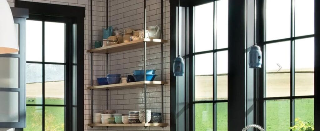 A kitchen with shelves and windows in it