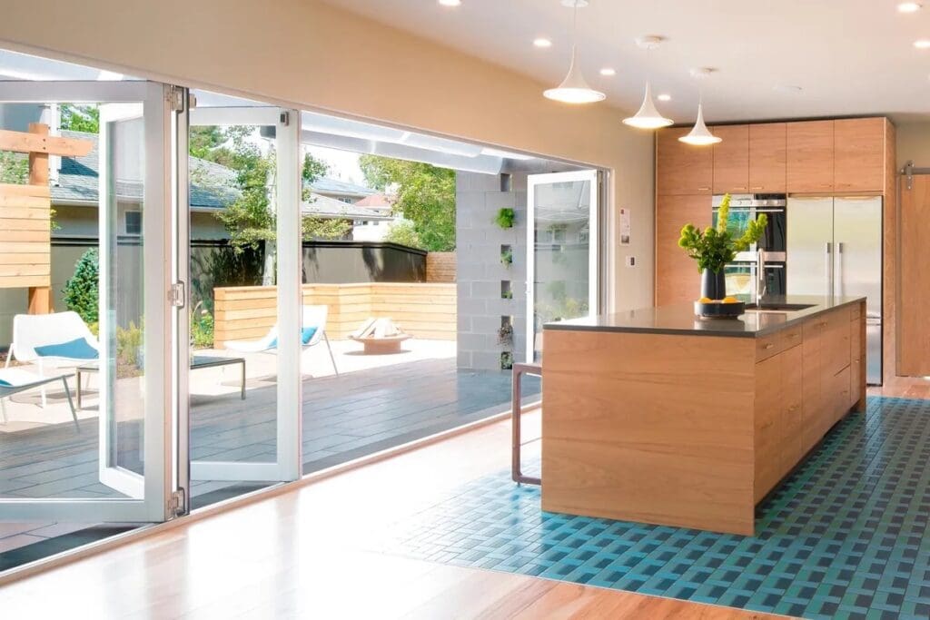 A kitchen with sliding glass doors open to the patio.