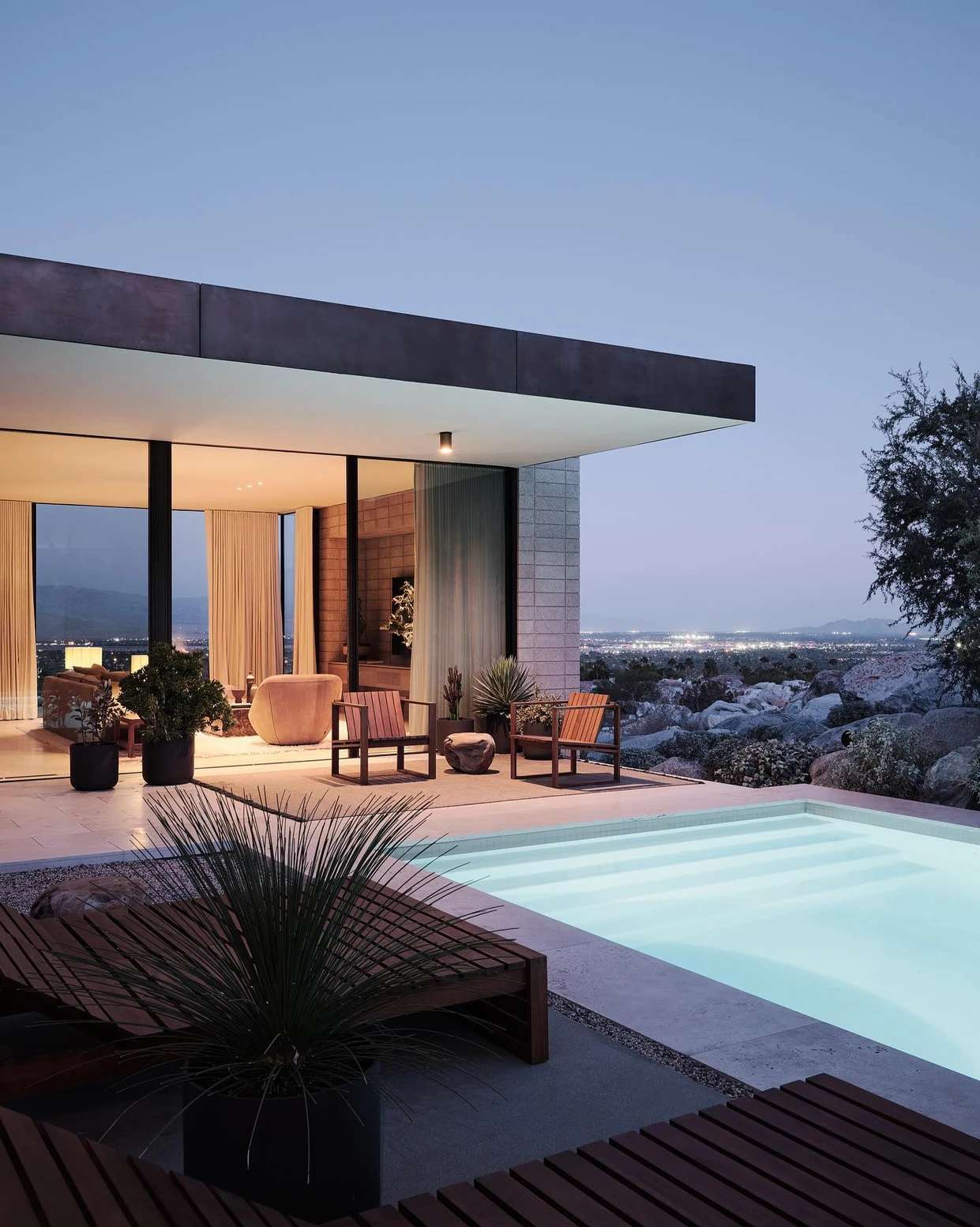 A pool with chairs and tables in the middle of it