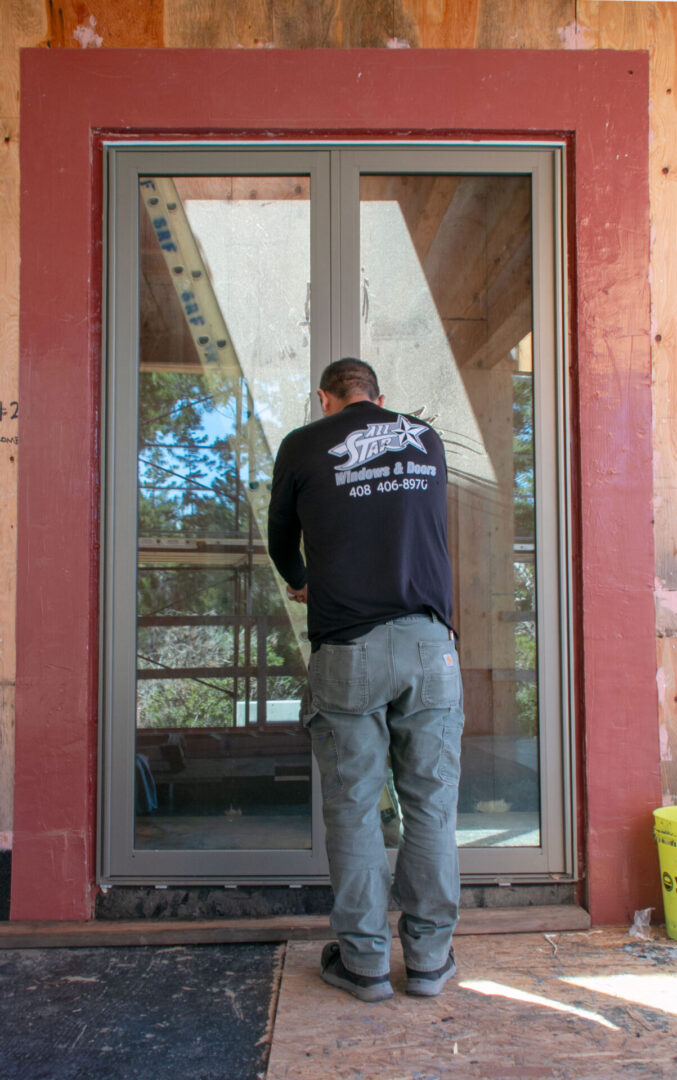 A man standing in front of a window.